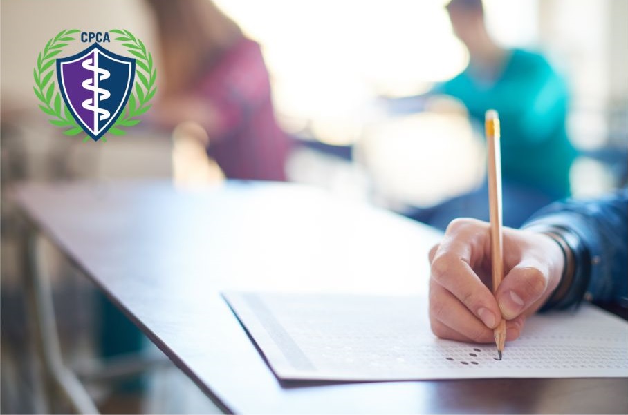 Close-up of a student filling out an exam sheet with a pencil, with the CPCA logo visible, representing practical assessment in aesthetic training and certification